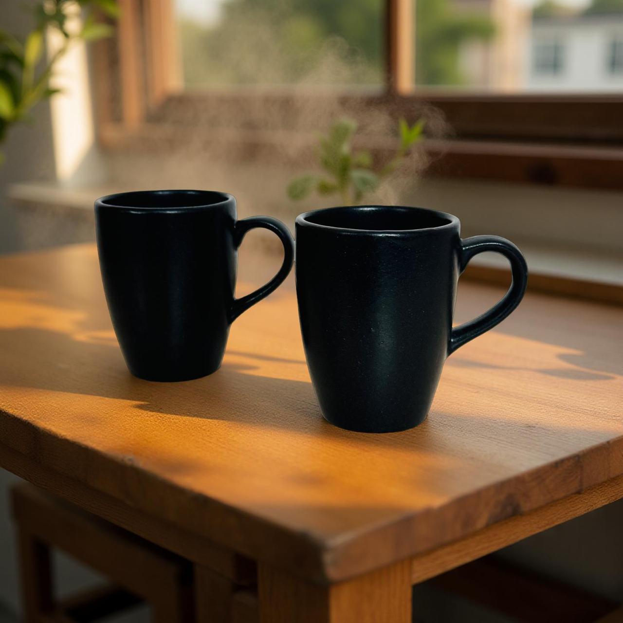 ceramic black coffee mug set of 2 kept on a wooden surface
