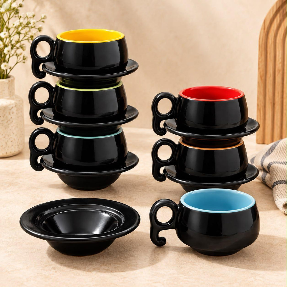 Multicolour ceramic coffee cups with glossy black exteriors for cappuccino and espresso serving