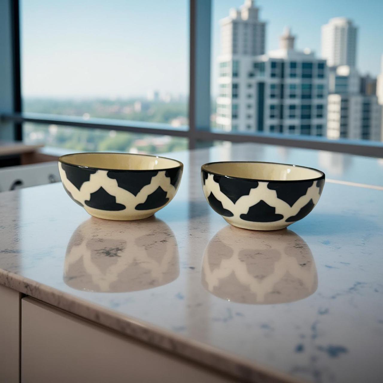 Two black and white patterned bowls on a reflective surface with a cityscape in the background