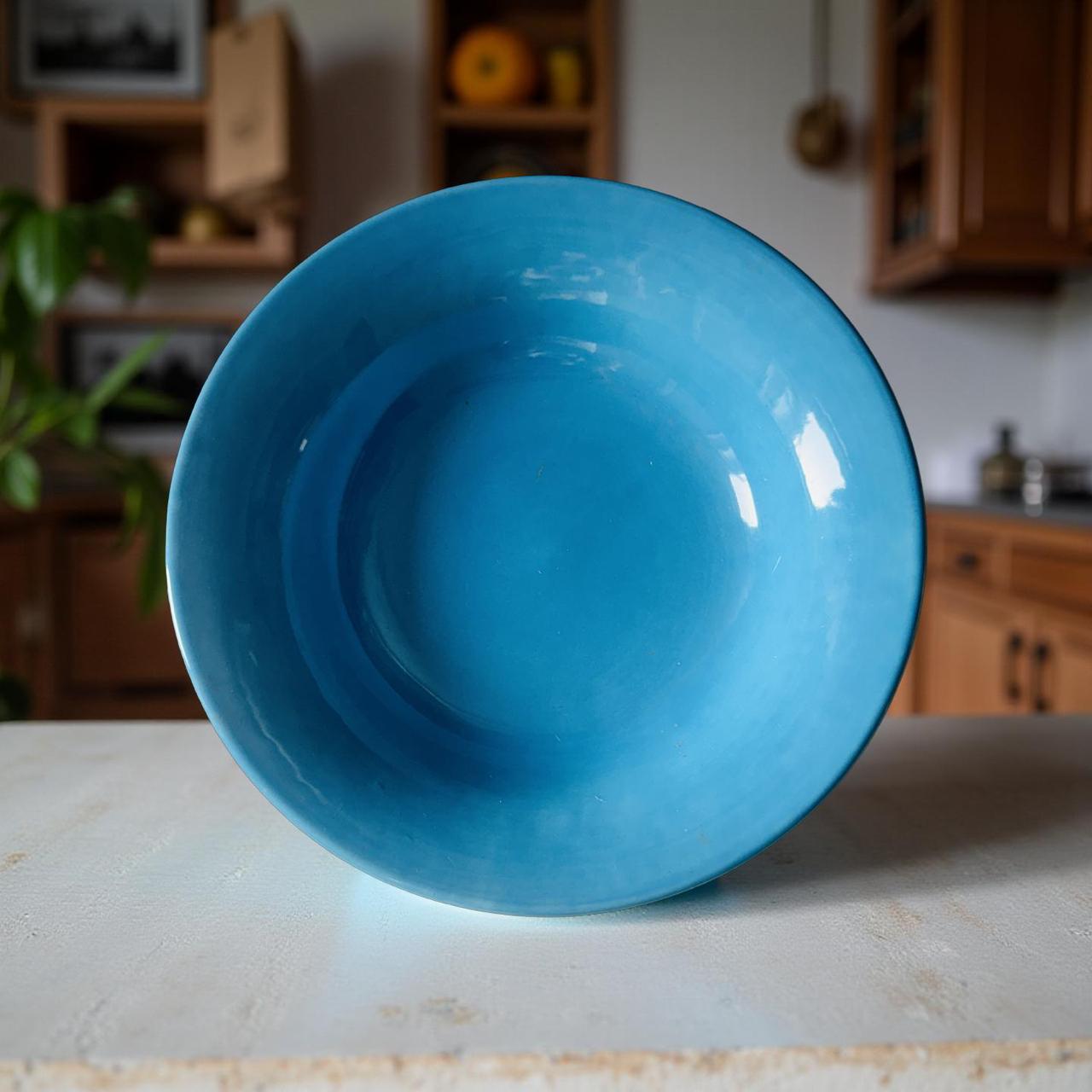 Blue ceramic bowl on a kitchen counter with blurred background