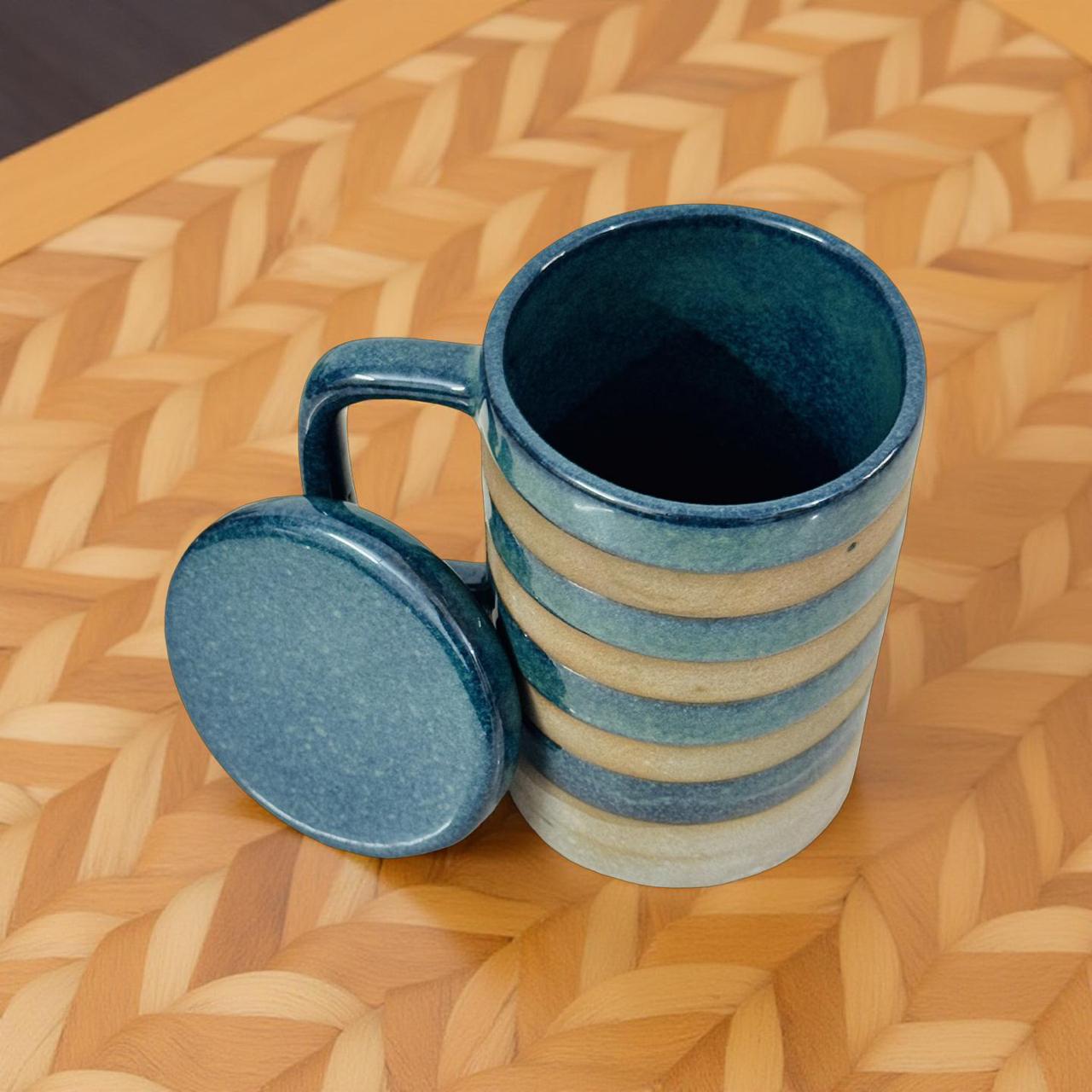 Blue ceramic mug with lid on a woven surface
