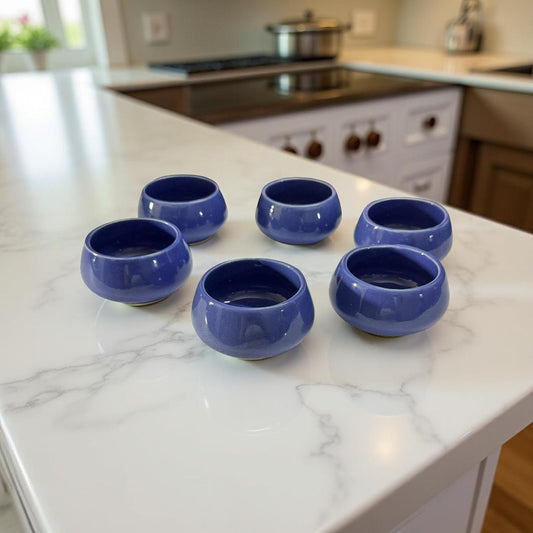 Set of six handcrafted blue ceramic chutney bowls on marble kitchen counter, perfect for gifting.