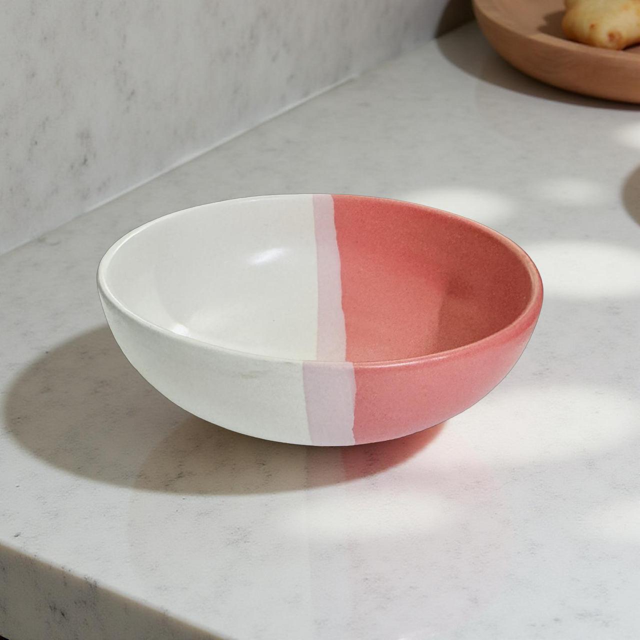 Ceramic bowl with white and pink design on a marble surface