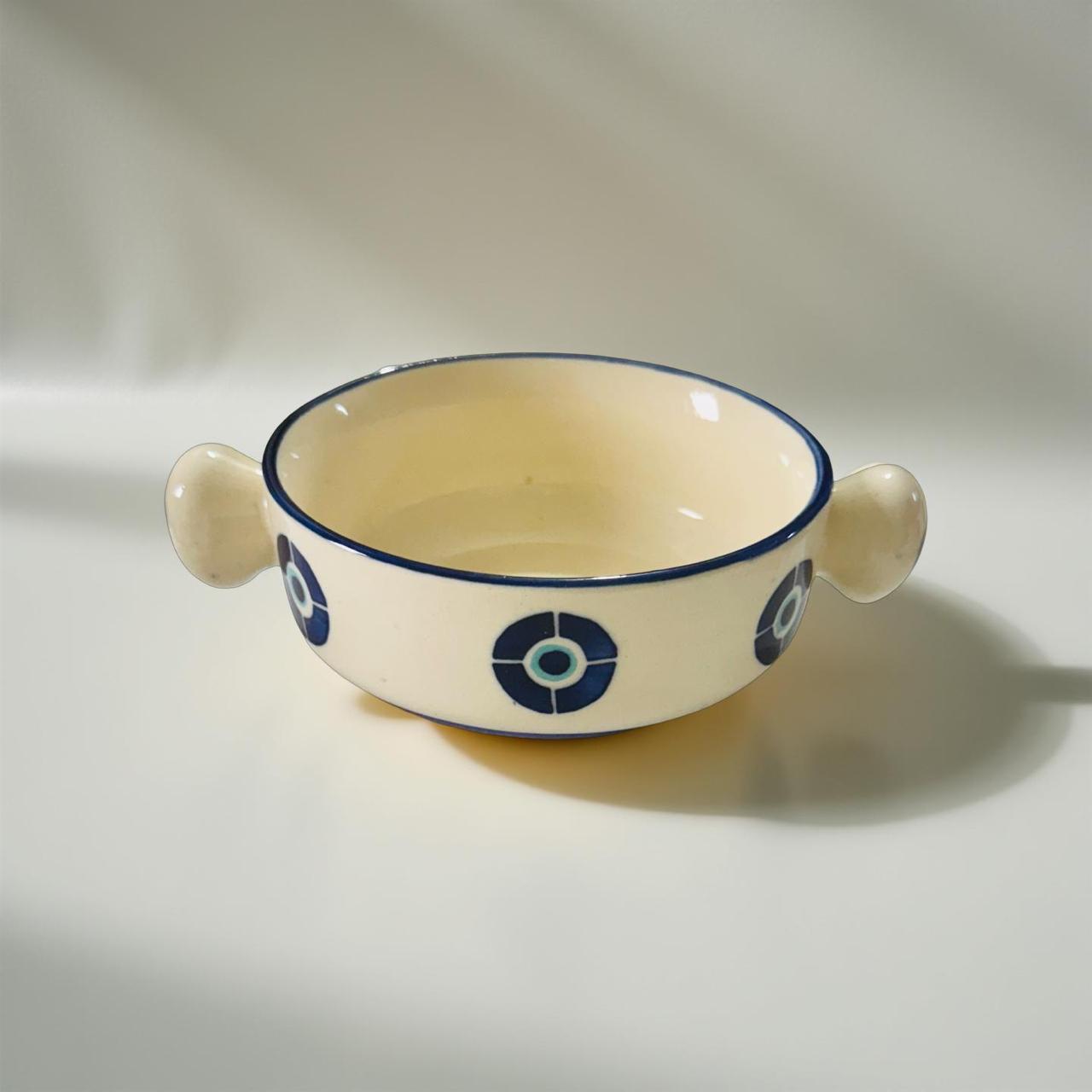 Ceramic bowl with blue decorative elements on a white background