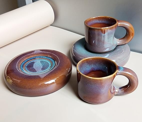 Handcrafted ceramic mug and saucer set with brown and purple glaze