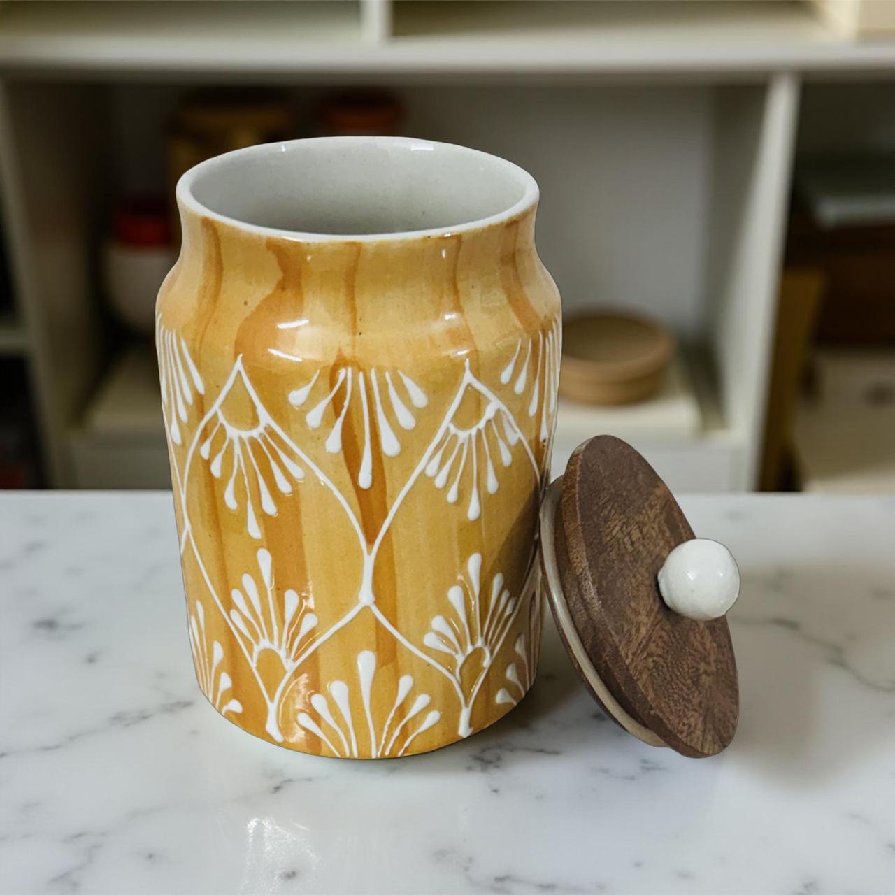 Ceramic jar with a wooden lid on a marble surface