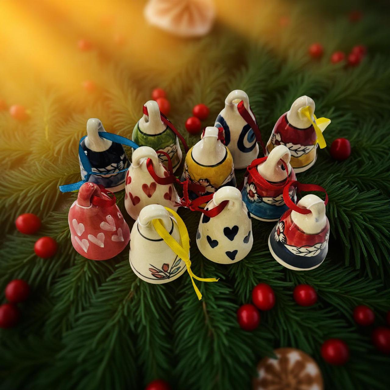 Decorative Christmas bells on a green leafy background with red berries