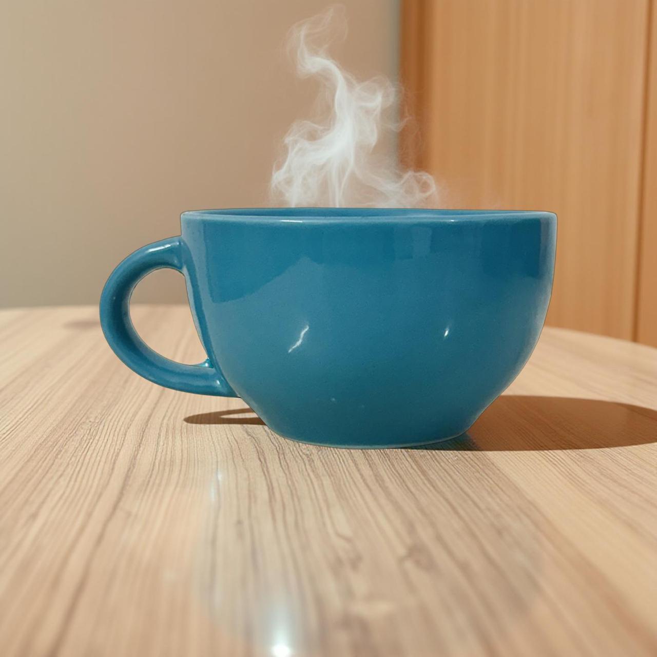 blue ceramic mug filled with hot coffee on a wooden surface