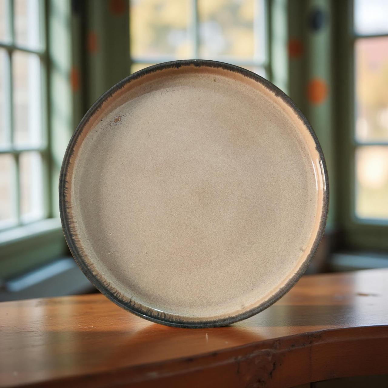 Round ceramic plate with a textured surface on a wooden table