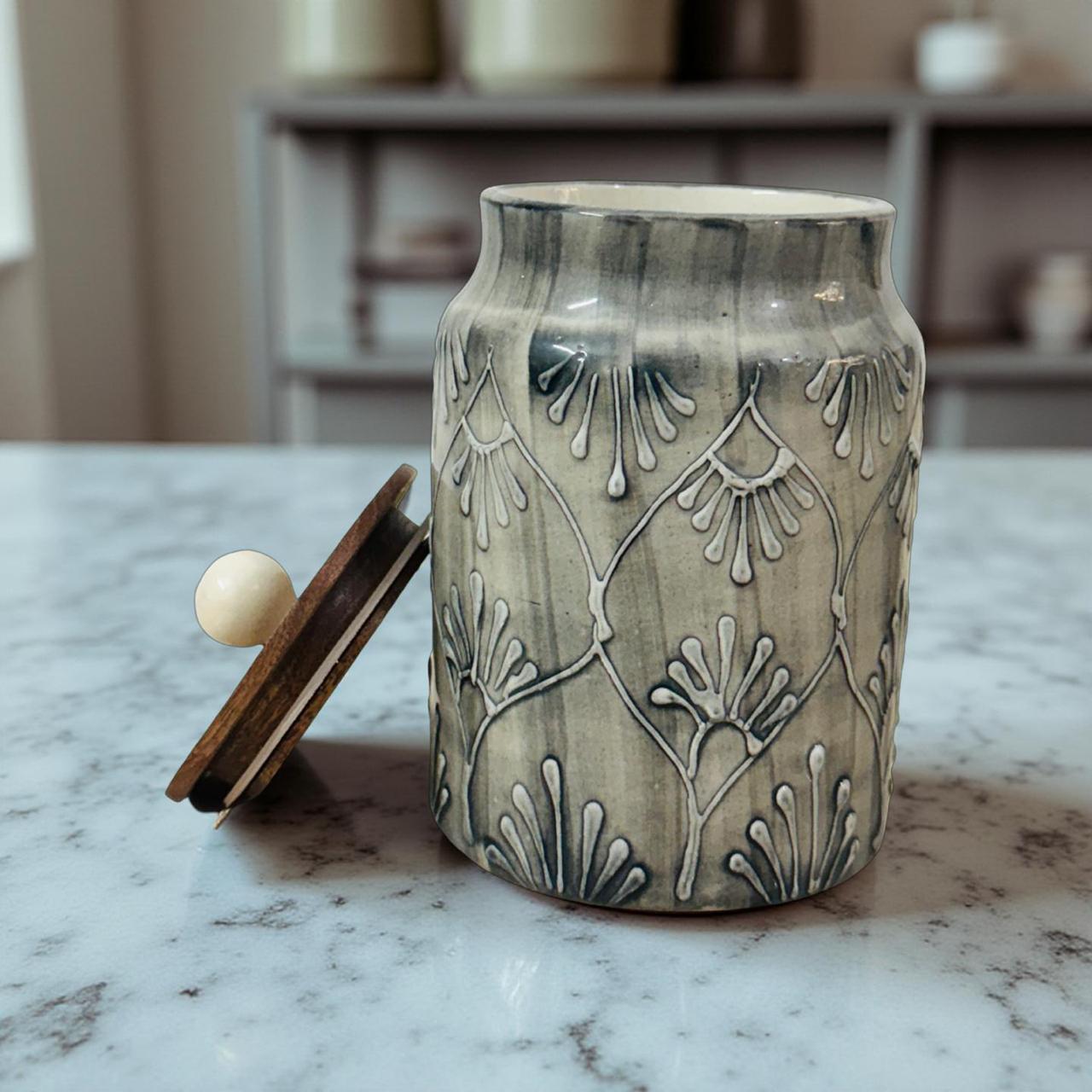 Ceramic jar with decorative lid on a marble surface