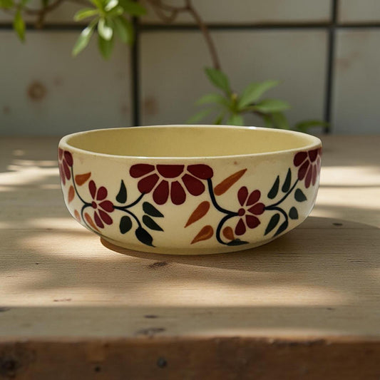 Decorative ceramic bowl with floral patterns on a wooden surface