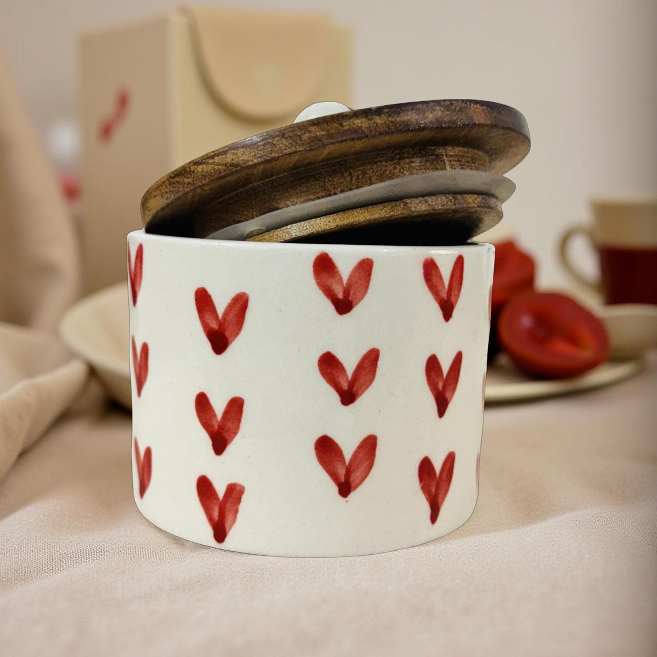 White container with red heart patterns on a beige surface