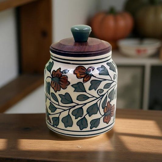 Decorative ceramic jar with floral patterns on a wooden surface