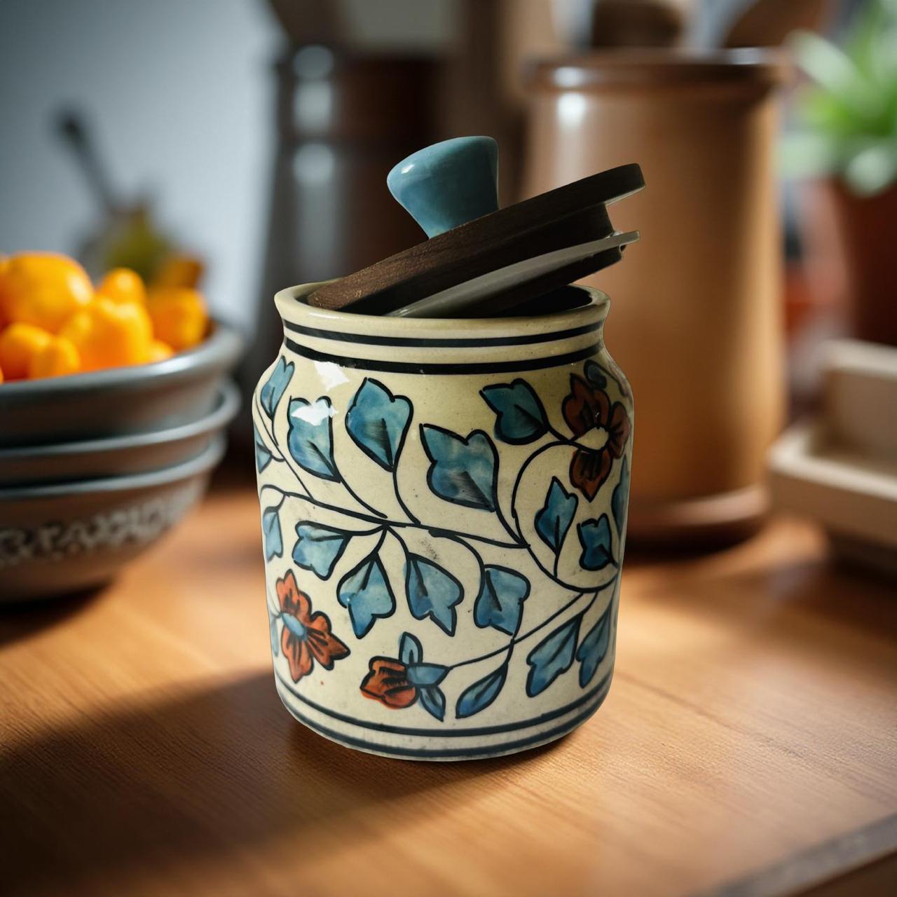 Decorative ceramic jar with floral patterns on a wooden surface