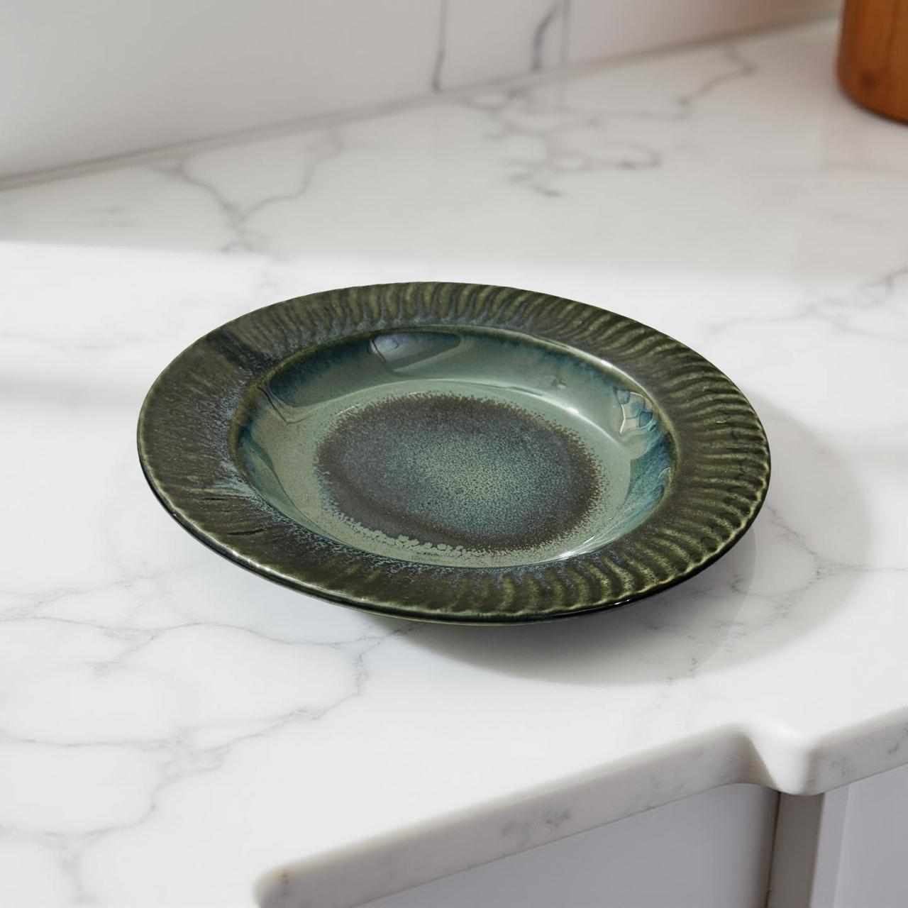 Green ceramic plate on a marble countertop