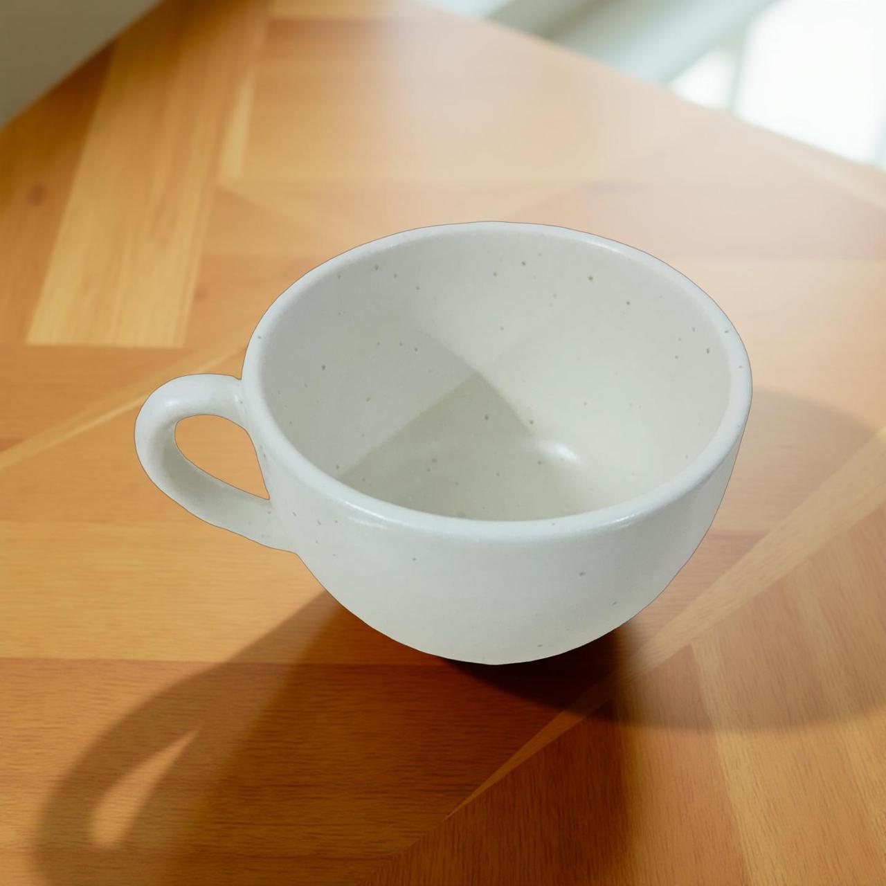 White ceramic cup on a wooden surface