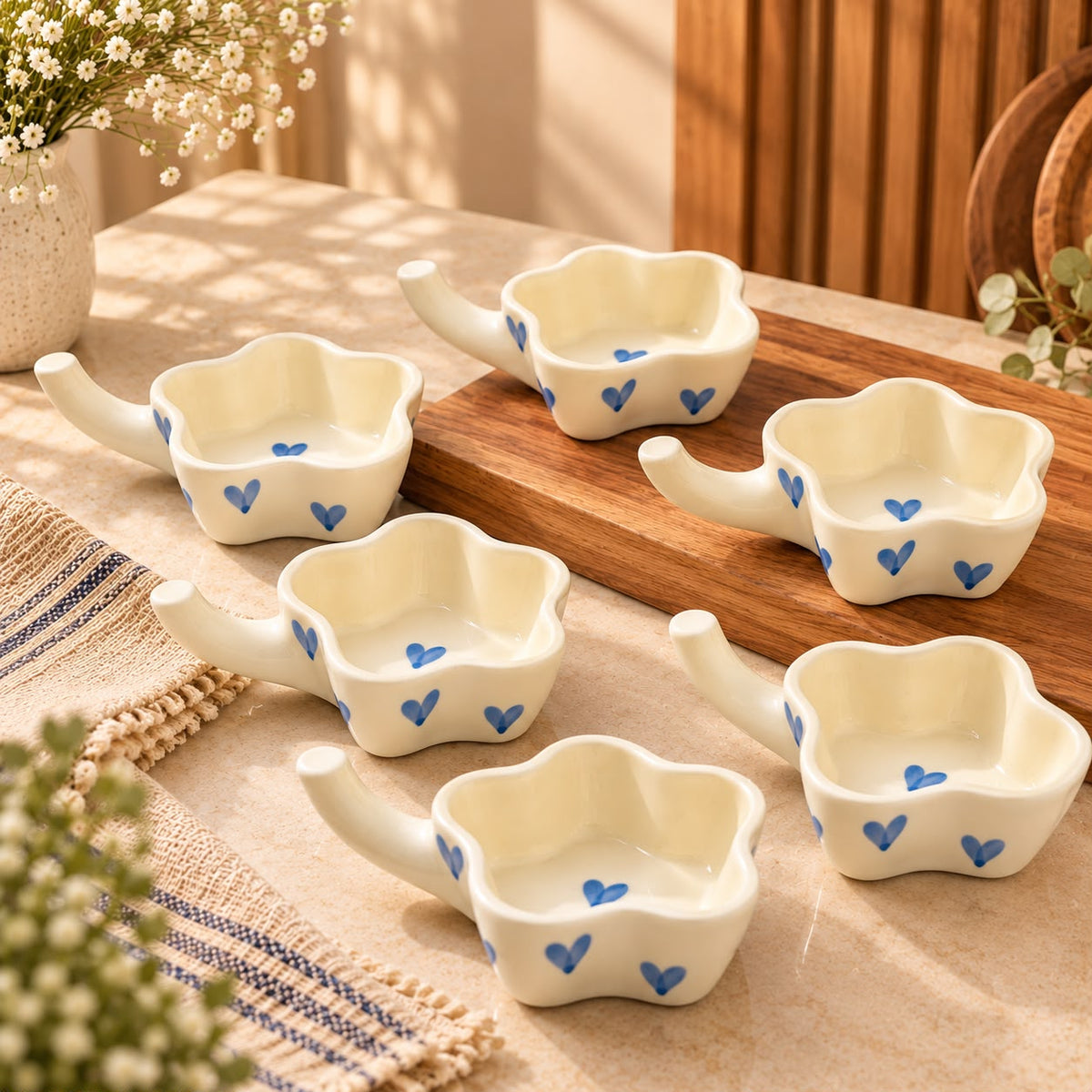 Blue heart patterned ceramic dishes displaying macarons, Indian mithai, cookies and chocolates