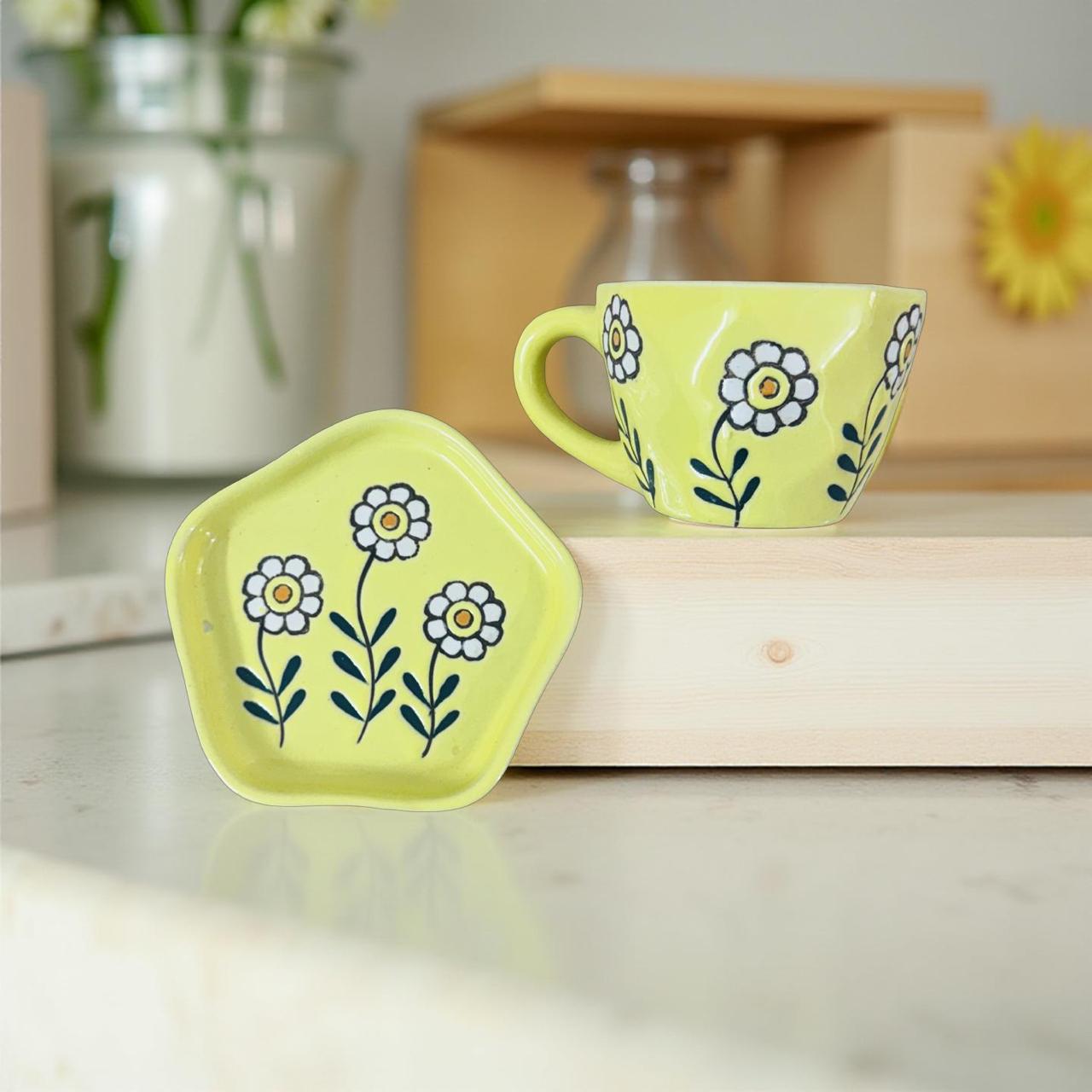 yellow mug and saucer set kept on a kitchen setting 