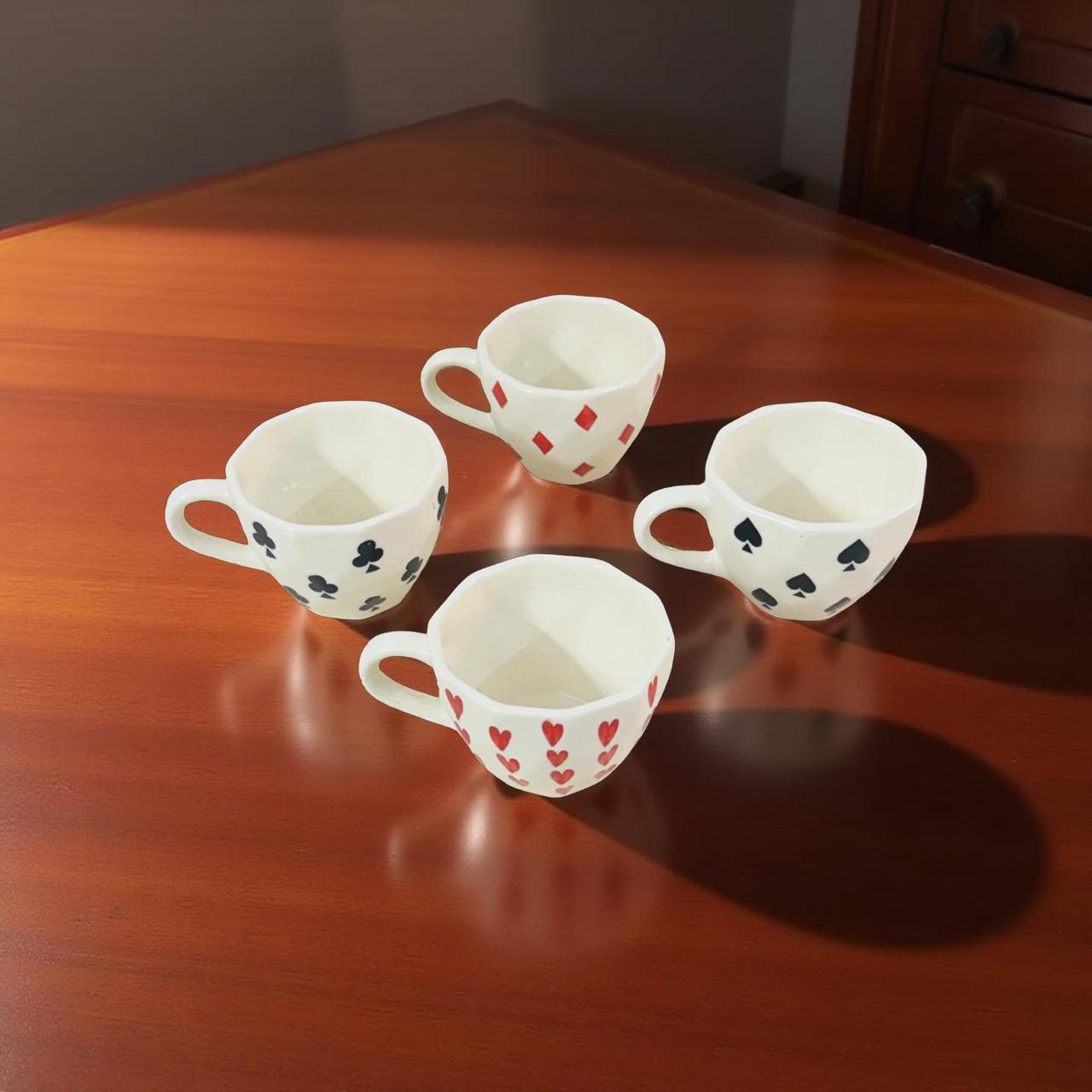 four party theme coffee mugs kept on a walnut finish coffee table