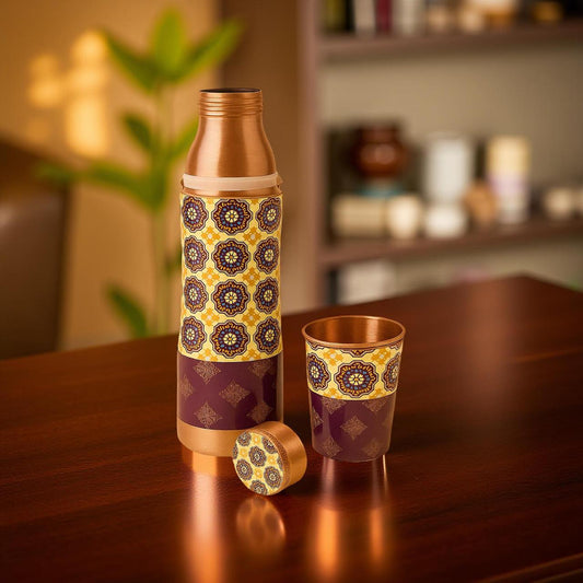 Copper bottle and cup with decorative patterns on a wooden table
