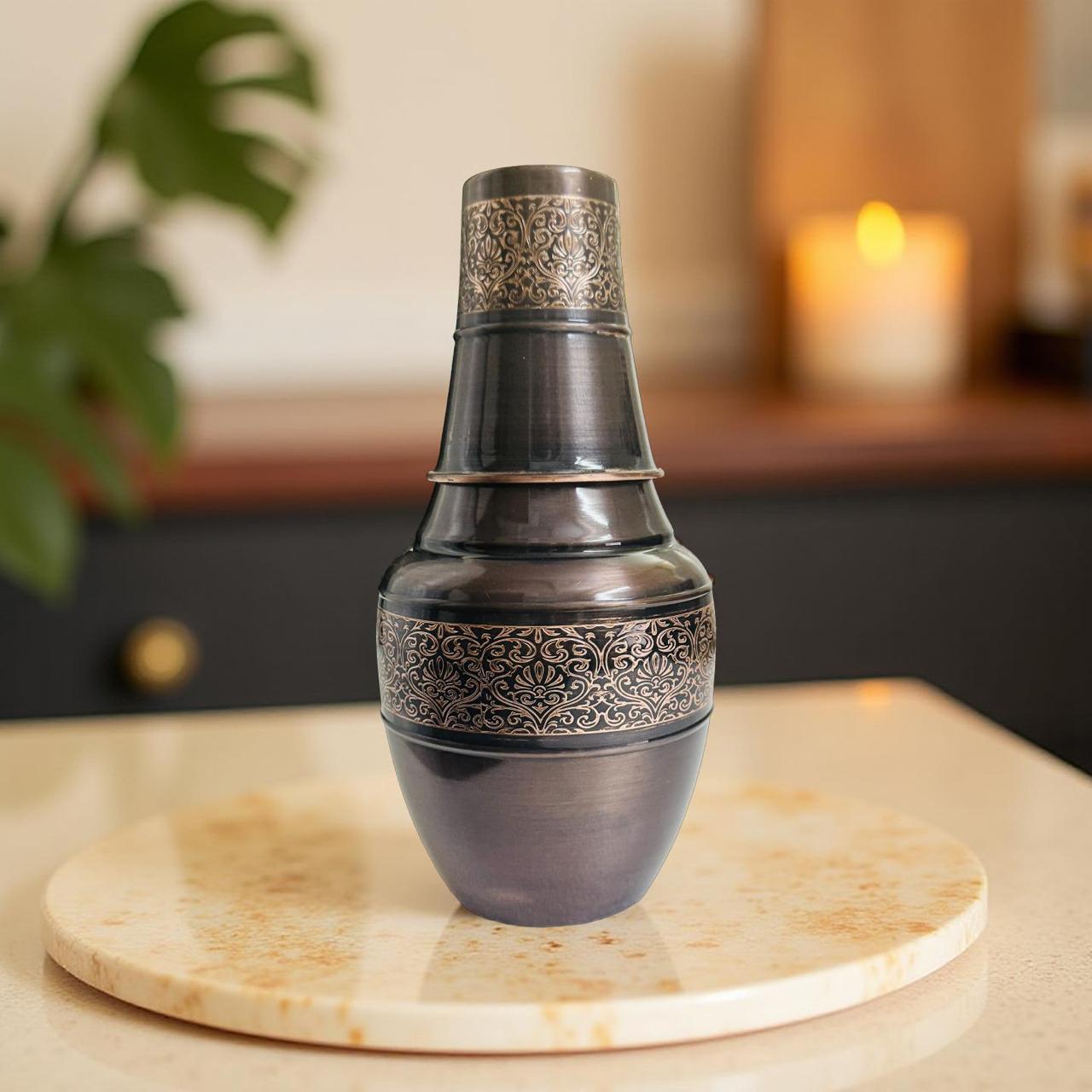Decorative copper pot with intricate patterns on a marble surface