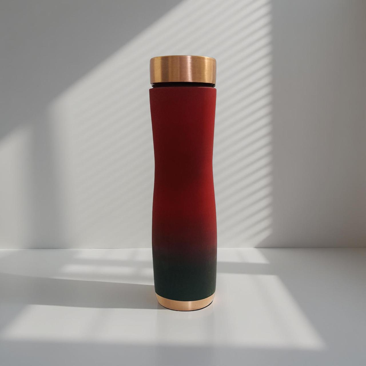 copper bottle with golden cap on a white surface