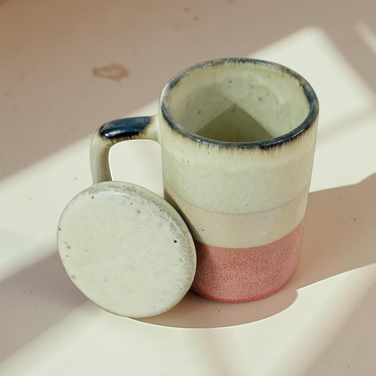 Ceramic mug with a matching lid on a light surface