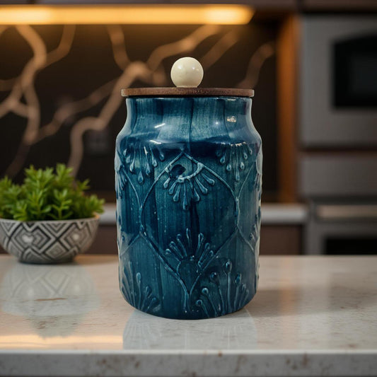 Blue textured ceramic storage jar with wooden lid styled on modern kitchen countertop
