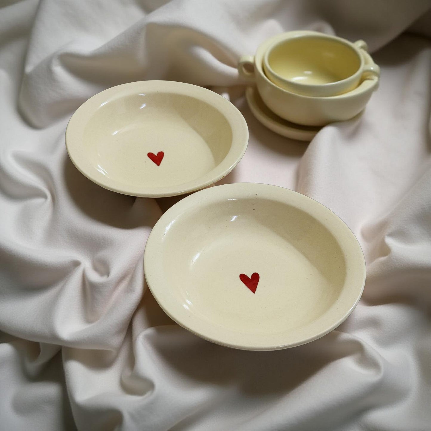 heart plates kept beutifully on a white silk cloth
