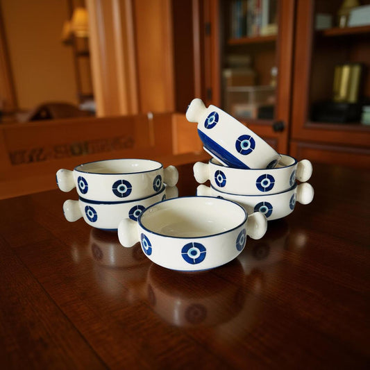 Set of ceramic bowls with blue patterns on a wooden surface