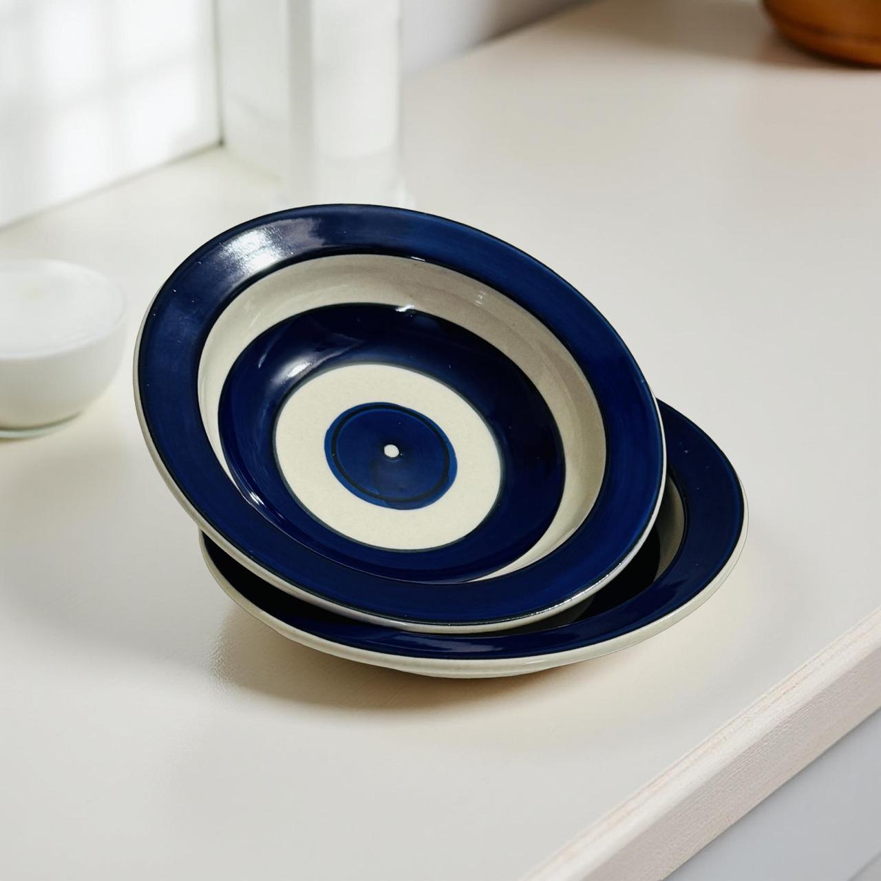 Set of blue and white ceramic plates on a light surface