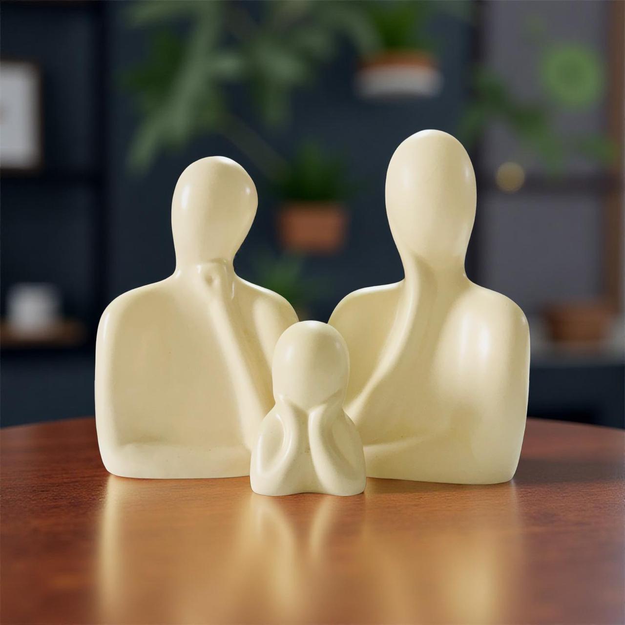 White ceramic family figurine on a wooden surface with a blurred indoor background