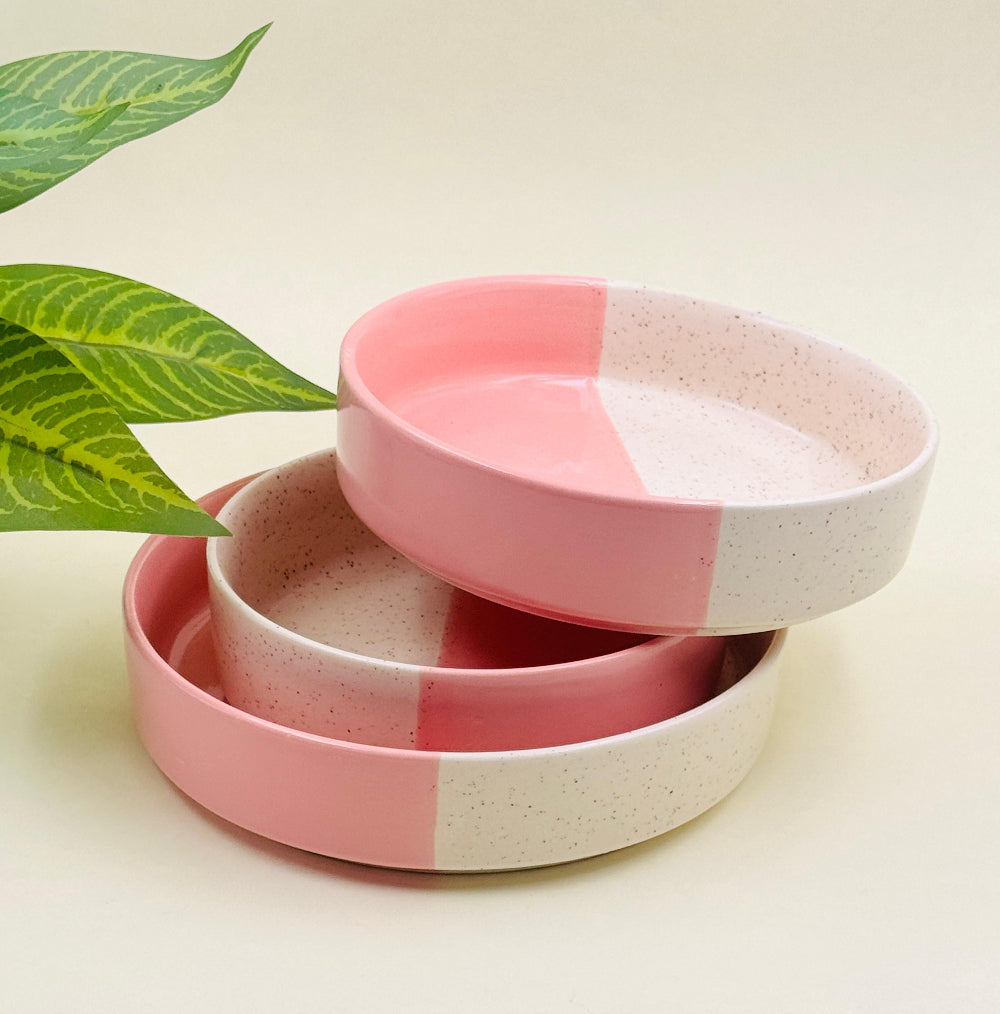 Natural clay-toned dishes photographed on a jute placemat with fresh greens and a bamboo spoon