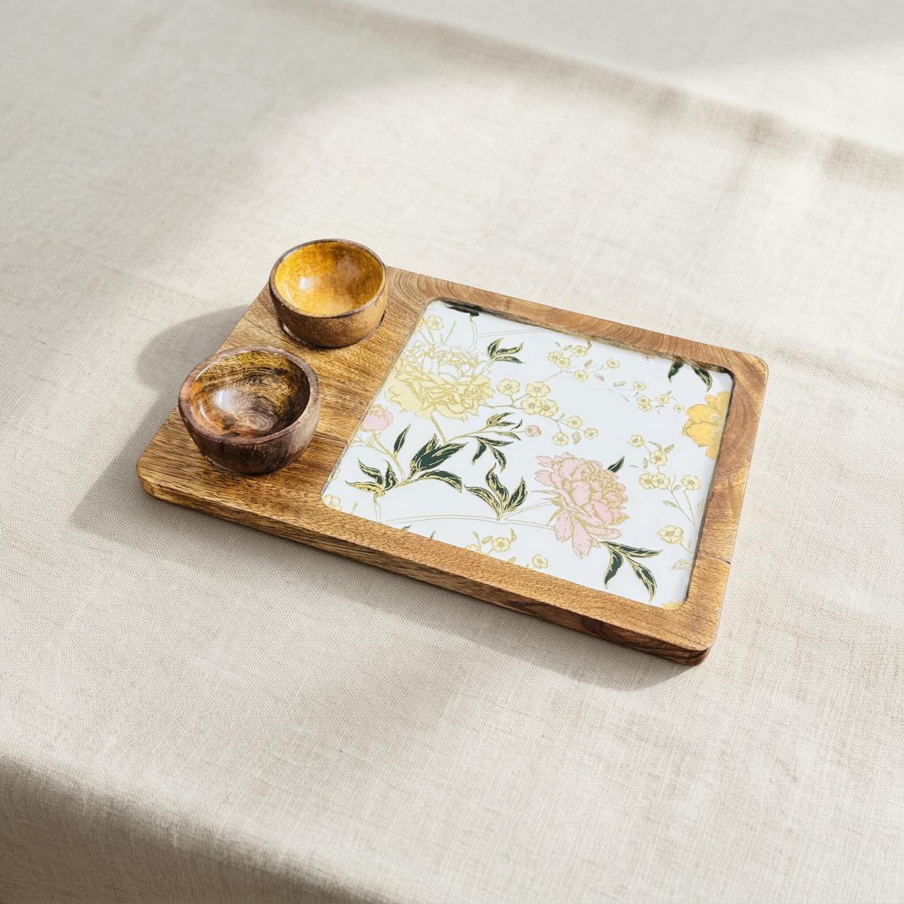Wooden tray with floral napkin and wooden bowls on a beige fabric background