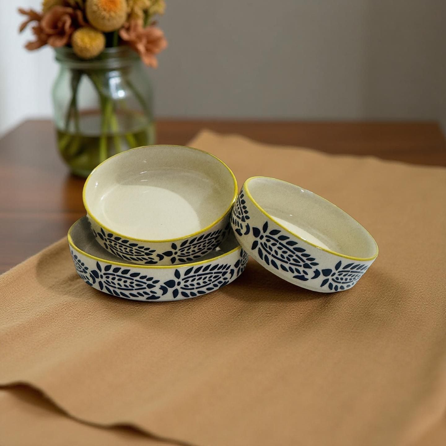 Set of ceramic bowls with floral patterns on a brown surface