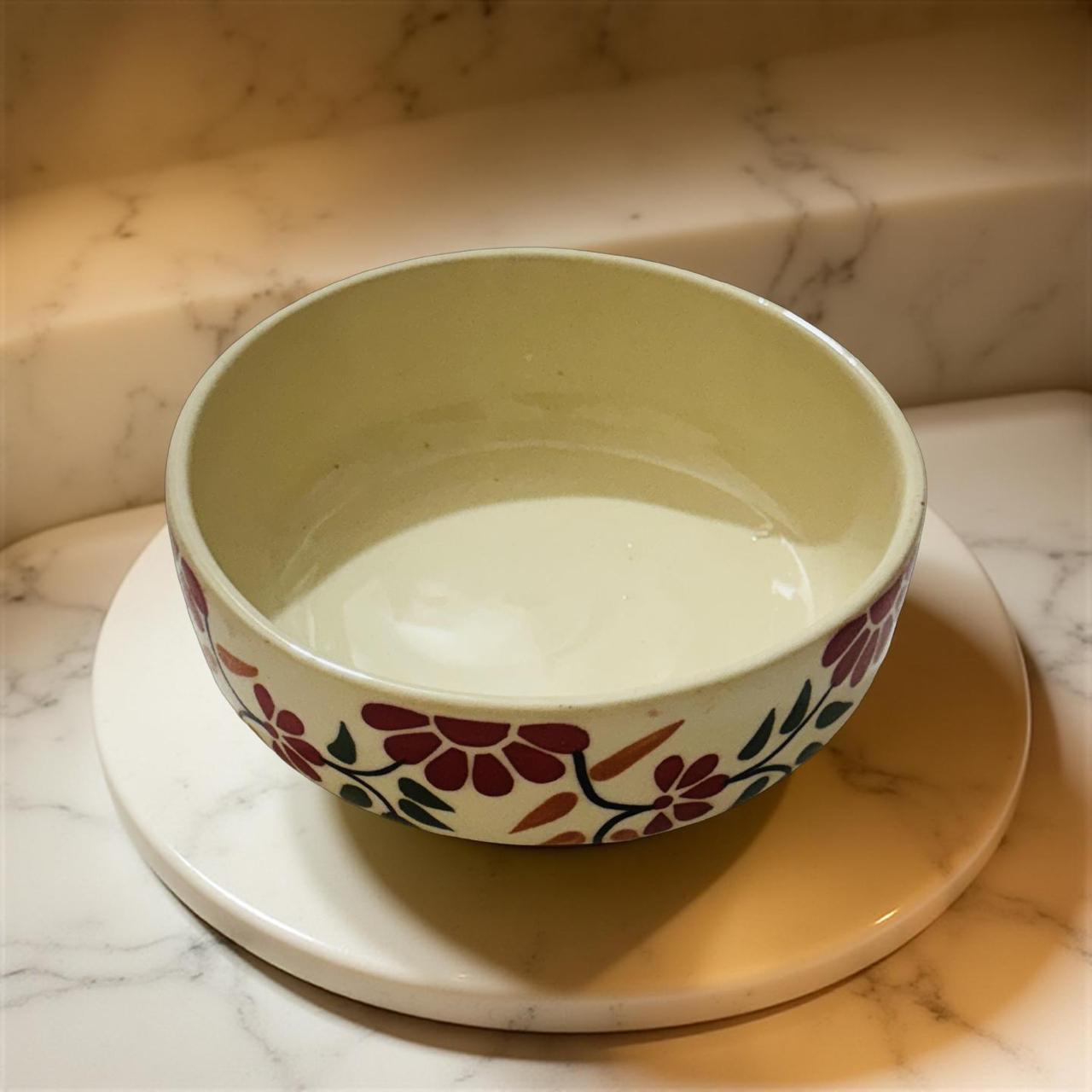 Decorative ceramic bowl with floral pattern on a marble surface