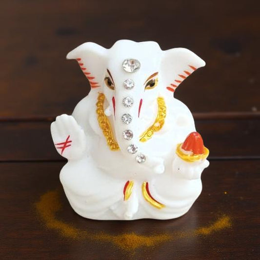 Decorative figure of ganesha statue on a wooden surface