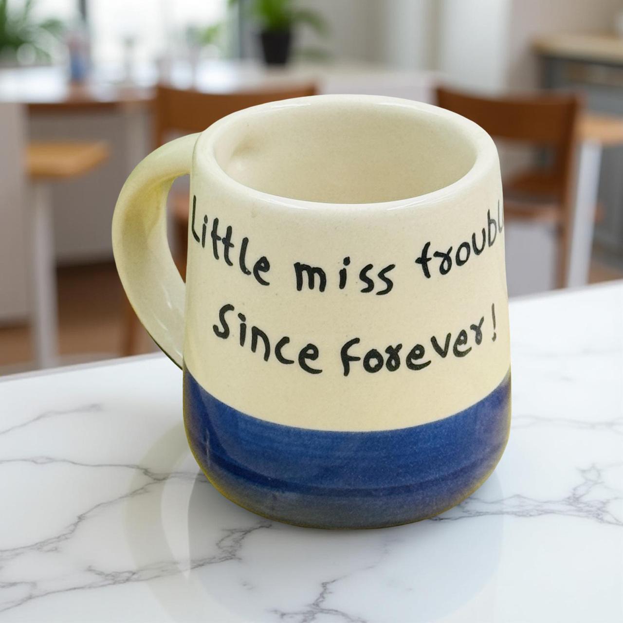 Mug with text 'Little miss trouble Since forever!' on a marble surface
