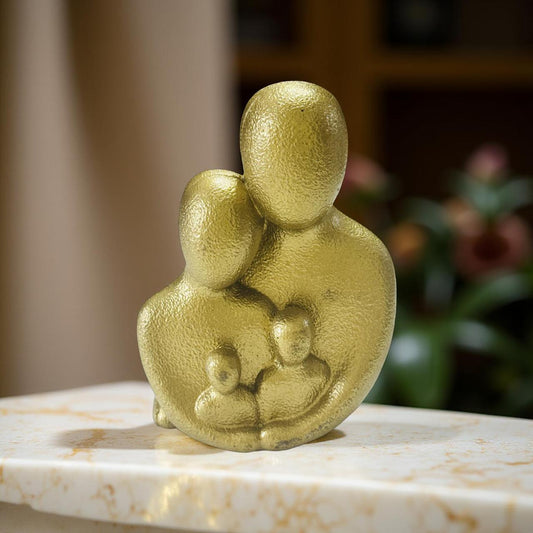 Gold family figurine on a marble surface with a blurred background