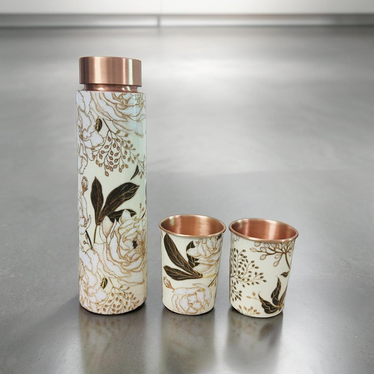 Set of ceramic tumblers with floral patterns and copper accents on a metallic surface