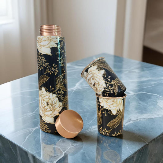 Floral-patterned water bottle and cap on a marble surface