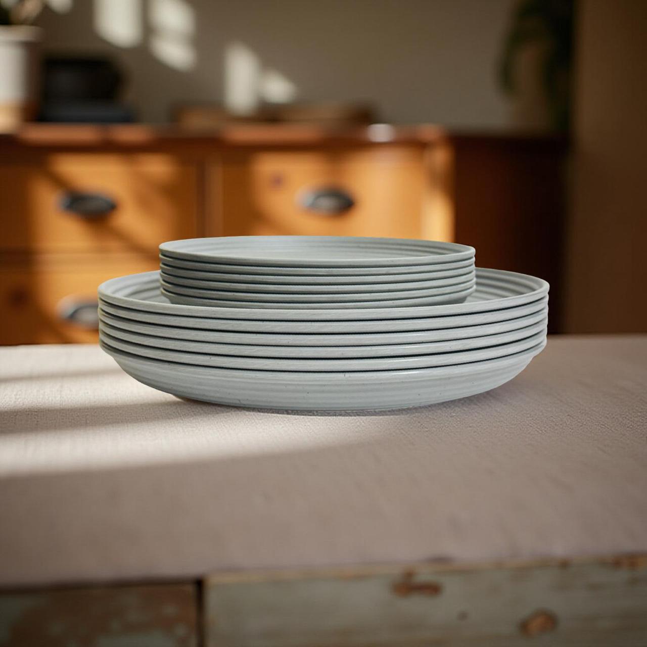 Stack of light blue melamine plates on a wooden surface with a blurred background