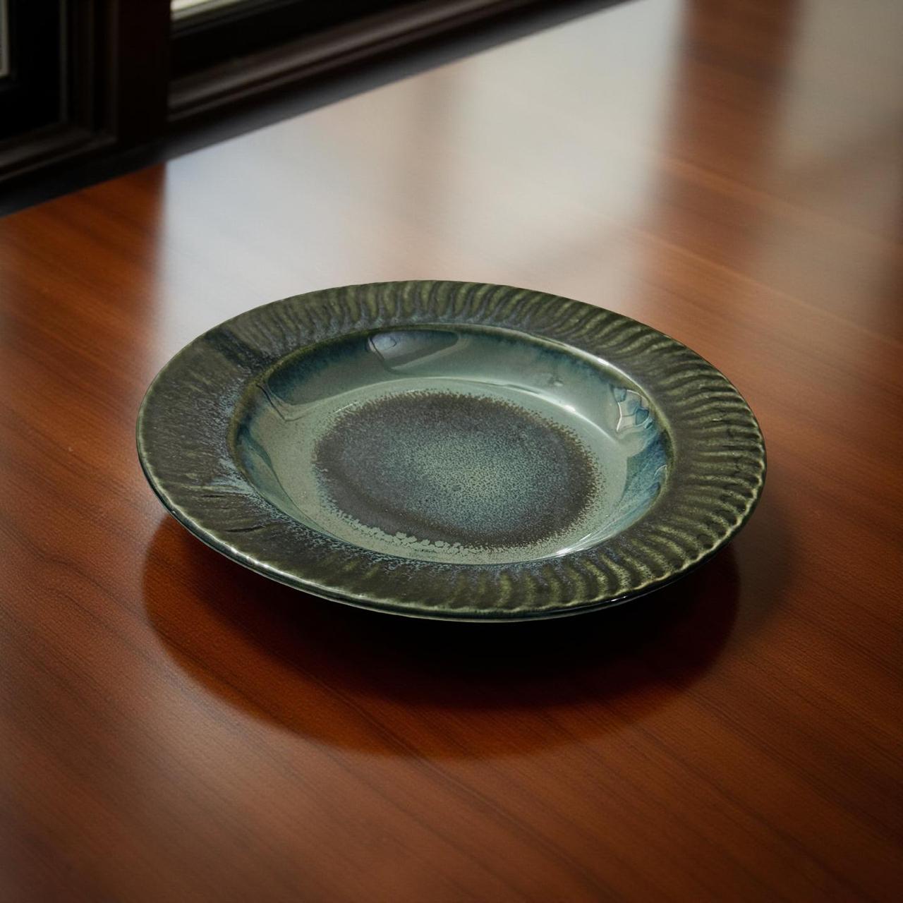 Green ceramic plate on a wooden surface