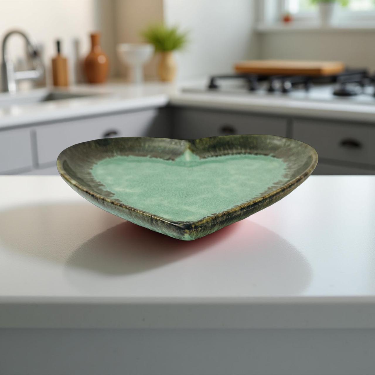 Heart-shaped green ceramic dish on a kitchen counter