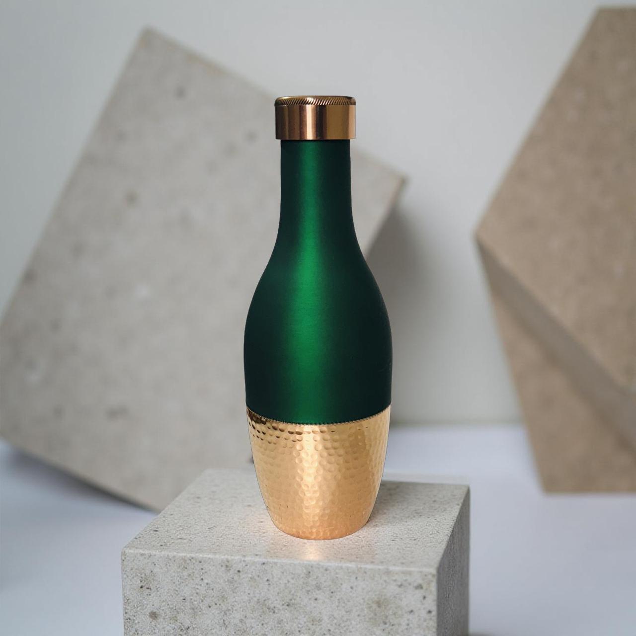 half green half copper bottle kept on concrete block