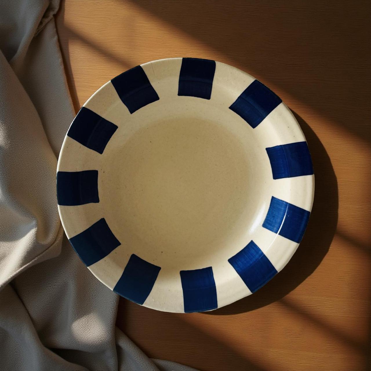 White plate with blue decorative rim on a wooden surface