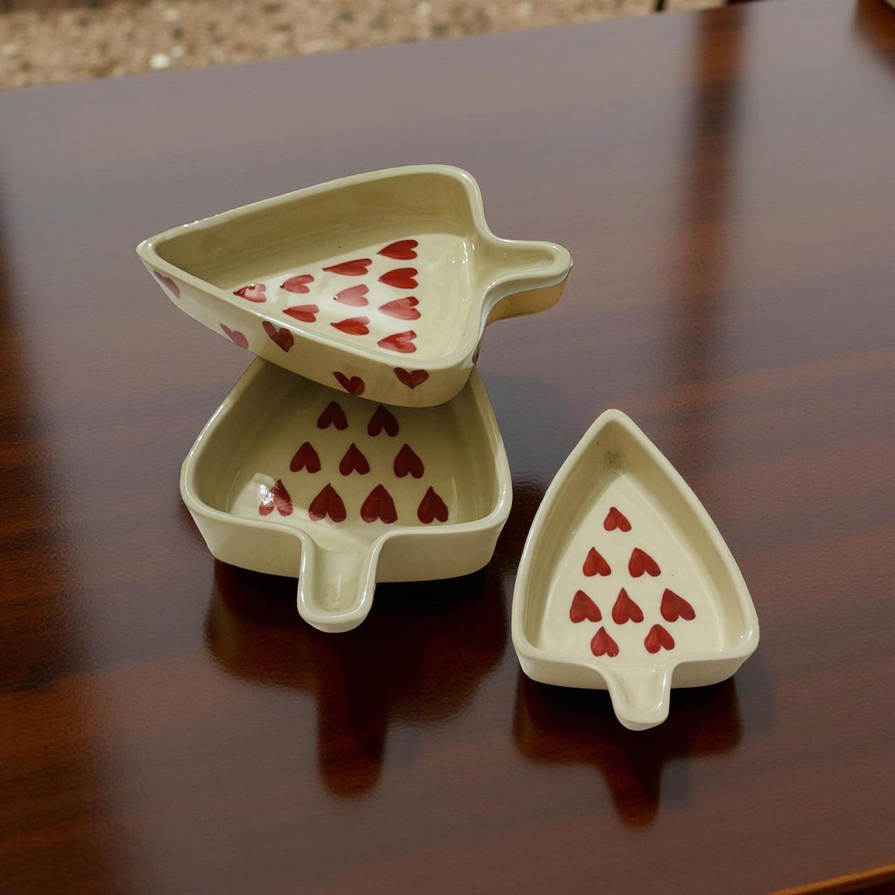heart motif ceramic bowls set of 3 resting on a wooden table