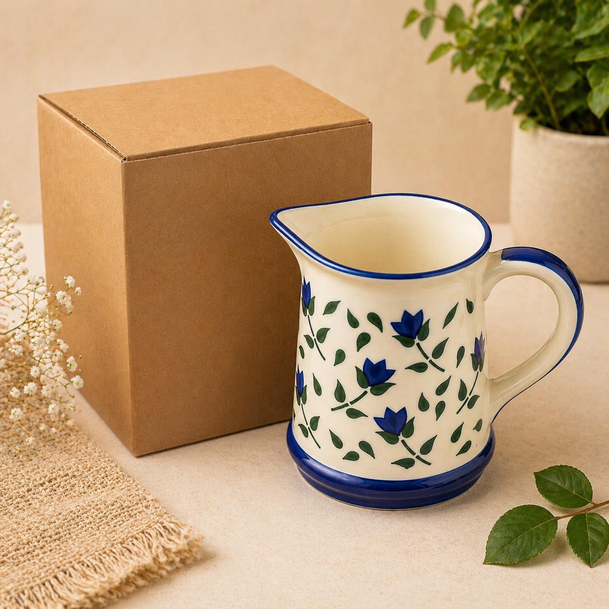 Ceramic pitcher with floral design on a neutral background
