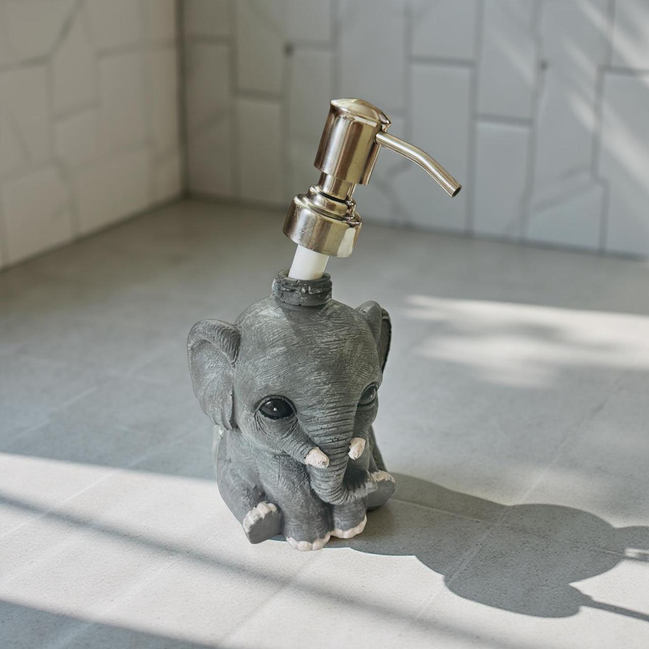 Gray elephant-shaped soap dispenser on a tiled bathroom counter