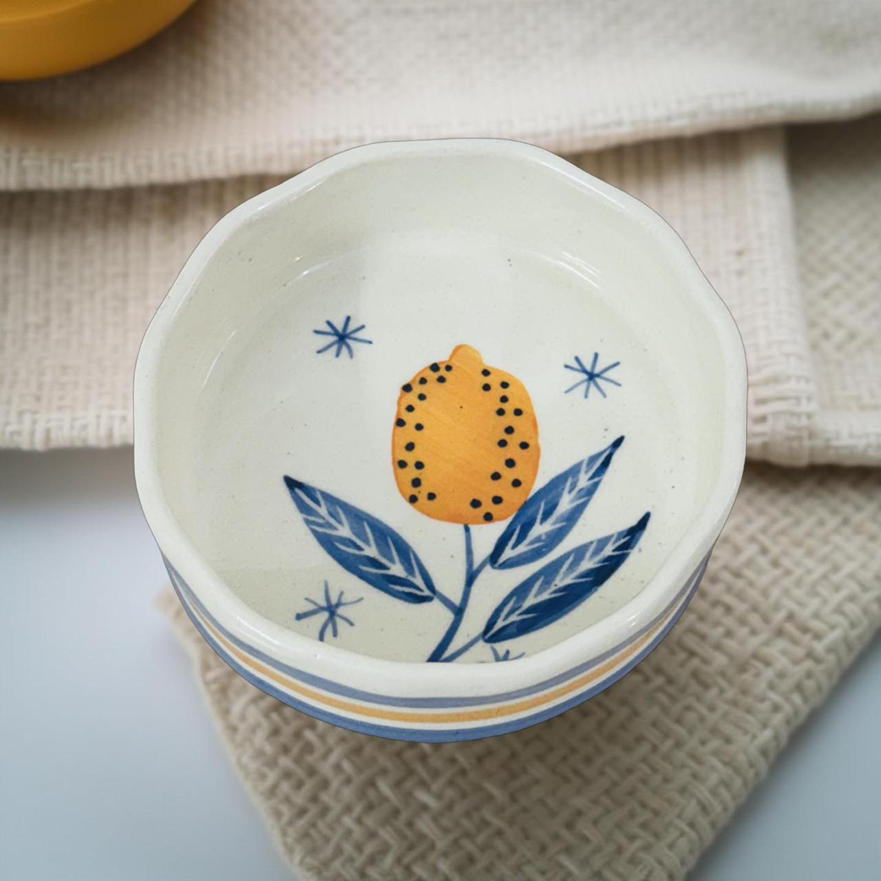 Ceramic bowl with floral design on a textured surface